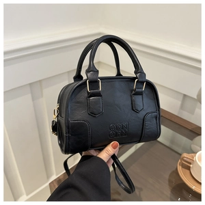 Detailed macro view of black PU leather handbag with embossed ORN logo and gold hardware