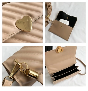 Detail view of heart-shaped gold lock, quilted texture and inner compartments of the bag