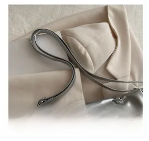 Detail of silver metallic tote bag with pleated texture and stylish shoulder strap
