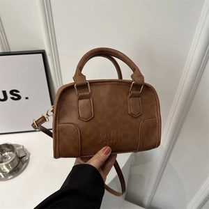 Retro brown leather Boston bag with embossed logo and elegant cylindrical top handles