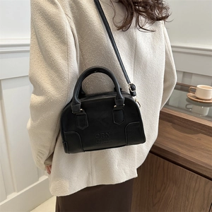 Retro black leather Boston handbag with adjustable shoulder strap and top handles
