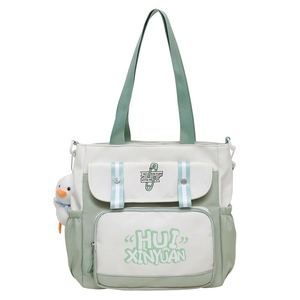 Detail view of large capacity canvas backpack with cute duck pendant and multi-pocket design