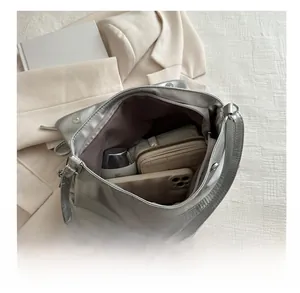 Interior view of silver metallic tote bag showing large capacity for phone and wallet