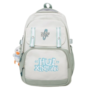 Detail of nylon backpack featuring a front pocket and cute plush duck charm accessory