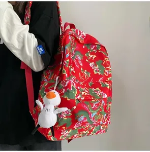 Side view of a floral ethnic backpack with traditional dragon pattern and duck pendant
