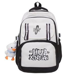 Detail of minimalist black and white canvas backpack with plush duck charm and large pockets
