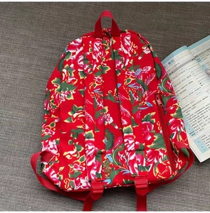 Close-up of red floral canvas backpack with traditional Chinese peony flower pattern