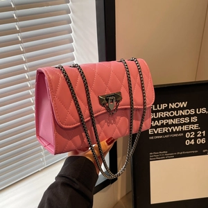 Pink quilted crossbody bag with metal chain strap and twist-lock closure for women
