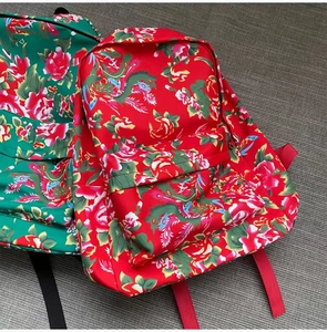 Close-up of traditional peony and phoenix floral patterns on large capacity canvas backpacks