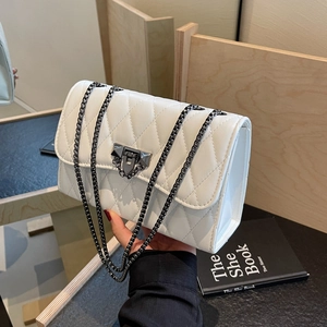White quilted crossbody bag with diamond stitch pattern and charcoal chain strap