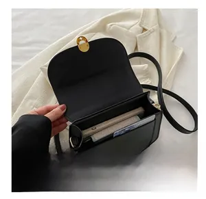 Top view of black leather shoulder bag interior showing large capacity for phone and wallet