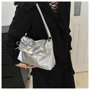 Silver bow shoulder bag with pleated detail on black lace dress outfit display