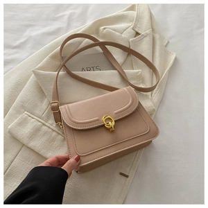 Close-up of beige crossbody square bag featuring a gold chain buckle and smooth flap design