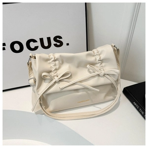 Detailed macro view of cream white tote bag with elegant bow knots and pleated texture