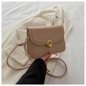Close-up of a beige PU leather crossbody bag featuring a golden metallic twist lock closure