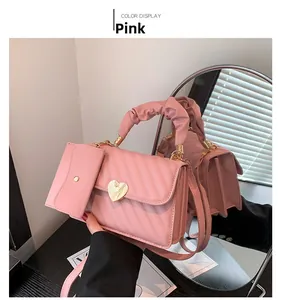 Pink quilted crossbody bag detail with heart buckle and stylish pleated top handle