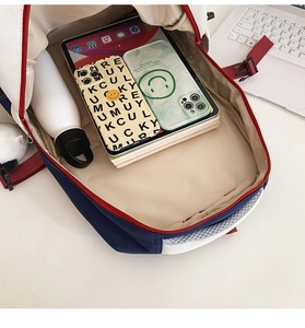 Detail view of large capacity backpack interior showing laptop and books storage