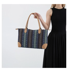 Detail showing the geometric woven fabric texture and brown leather handles of the tote bag