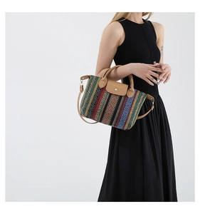 Close-up of woven tote bag featuring ethnic geometric patterns and leather magnetic closure