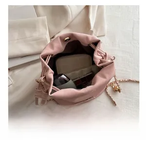 Pink matte bucket bag interior view showing capacity for wallet and cosmetics