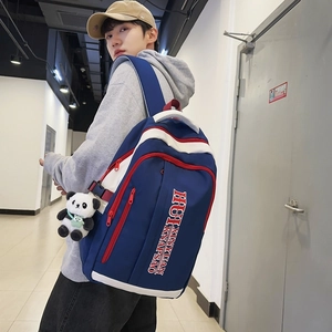 Large navy blue nylon school backpack with color blocking and panda pendant charm