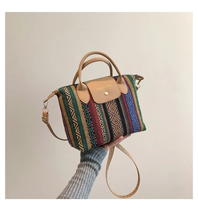 Close-up of geometric knit patterns and brown leather accents on this casual tote bag