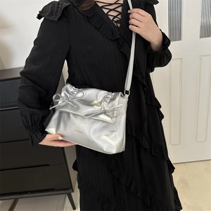 Silver metallic tote bag with bow detail and adjustable shoulder strap for women