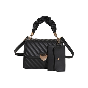 Black quilted crossbody bag with golden heart lock and scrunchie handle detail