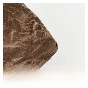 Close-up of a dark brown shoulder bag with unique wrinkled paper texture and matte finish