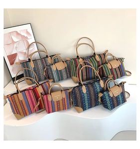 Detail view of ethnic geometric weave tote bags with leather handles and flap closures