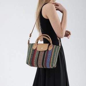 Bohemian woven tote bag with colorful geometric patterns and brown leather straps