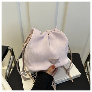Detail shot of lavender bucket bag with drawstring closure and chain shoulder strap