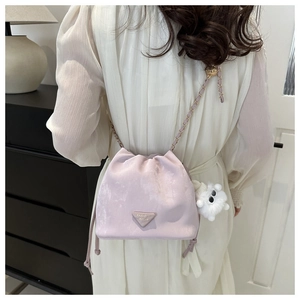 Detail of lavender bucket bag with chain strap and cute white sheep plush charm