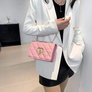 Pink quilted crossbody bag with golden heart clasp and chain strap for women