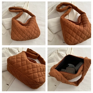 Macro detail of quilted corduroy shoulder bag showing interior space and brown fabric texture