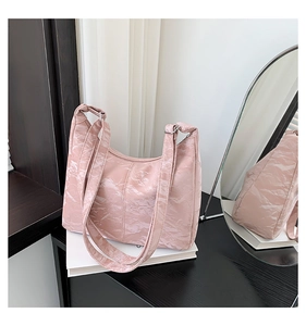 Detail of the pink wrinkled texture and glossy PU leather on this large Hobo shoulder bag