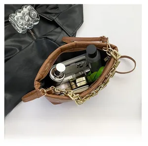 Top view of open brown quilted chain bag showing interior capacity and daily cosmetics