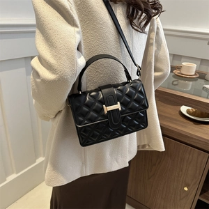 Classic black quilted crossbody bag with gold H-buckle and adjustable shoulder strap