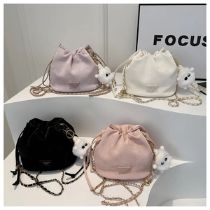 Group shot of four vintage drawstring bucket bags in lilac, cream, black, and soft pink tones