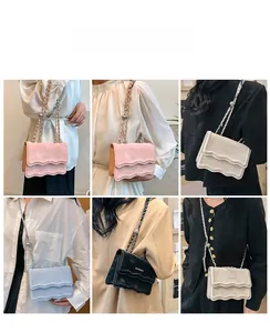 Detail view of wave-edged flap crossbody bags in pink, beige, blue, and black colors