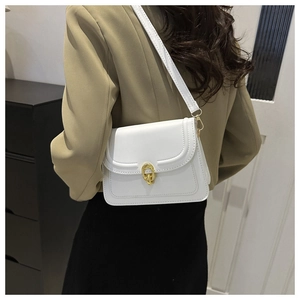 Close-up of white PU leather bag featuring a gold oval metal clasp and fine stitching detail