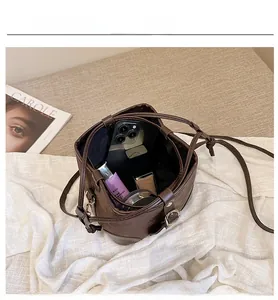 Macro view showing internal capacity of the brown leather bucket bag for daily essentials