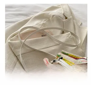 Detailed close-up of the colorful embroidered pattern and adjustable white leather strap