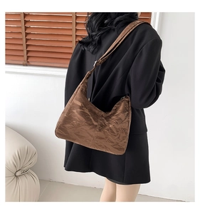 Detail of the brown crinkle texture shoulder bag showing spacious silhouette and material