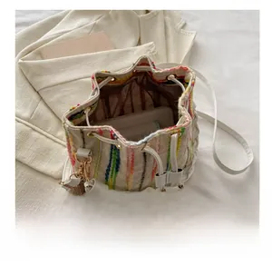 Vertical striped bucket bag interior showing capacity for phone and essentials