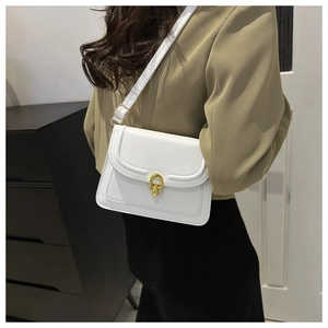 Detailed close-up of white PU leather crossbody bag with elegant golden interlocking buckle
