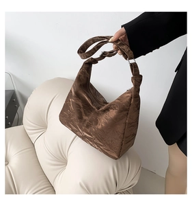 Detail of coffee brown tote bag with wrinkled metallic texture and wide strap