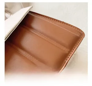 Close-up of contrast color leather handbag with detailed quilted stitching and soft texture