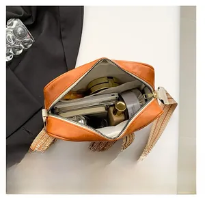 Top-down view of spacious interior of the faux leather camera bag showing daily essentials