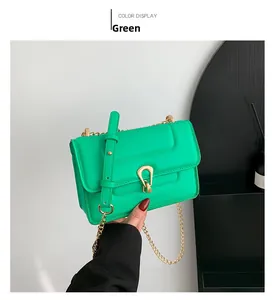 Détail du sac bandoulière vert montrant le fermoir fer à cheval doré et la chaîne